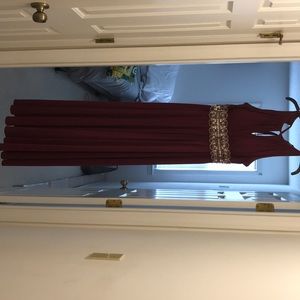 A slim flowy  maroon prom dress